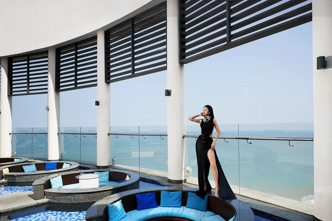 A model in a black gown on the pool terrace above the sea, Four Points by Sheraton Danang