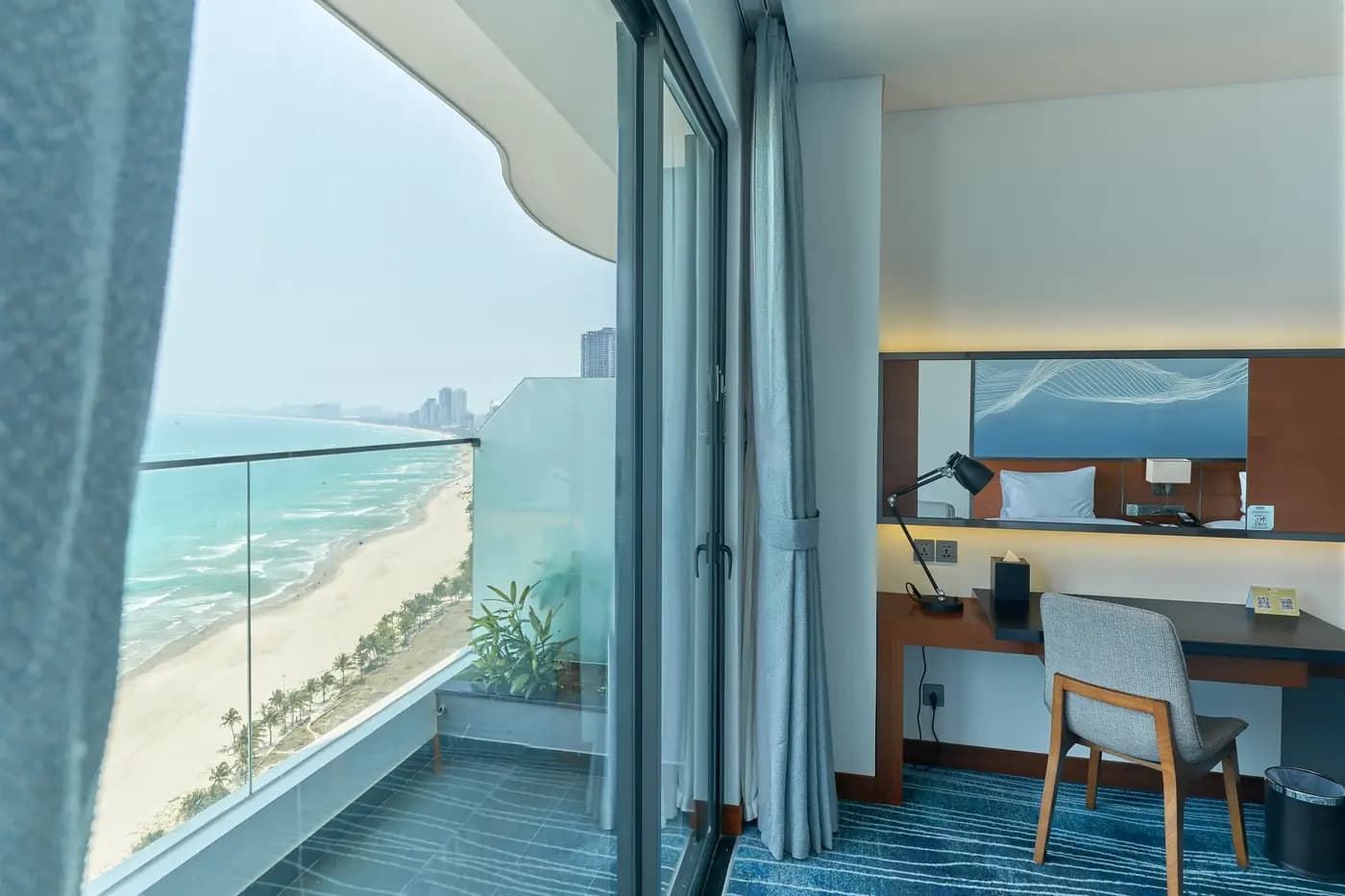 A guest room with a balcony over the beach, Hilton Garden Inn Danang