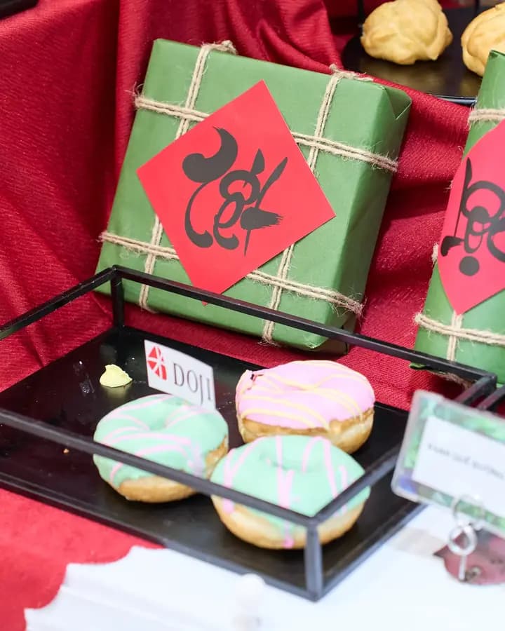 Tết gift parcels and pastries tagged with DOJI at a DOJI workshop event
