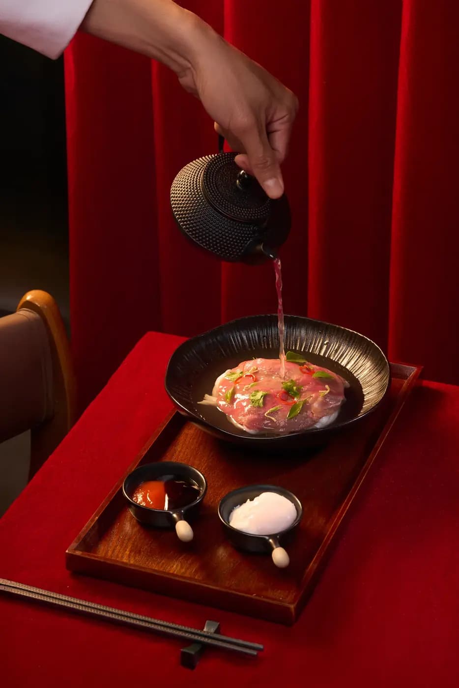 Tea poured into a bowl on a red table, Moulin de Da Nang